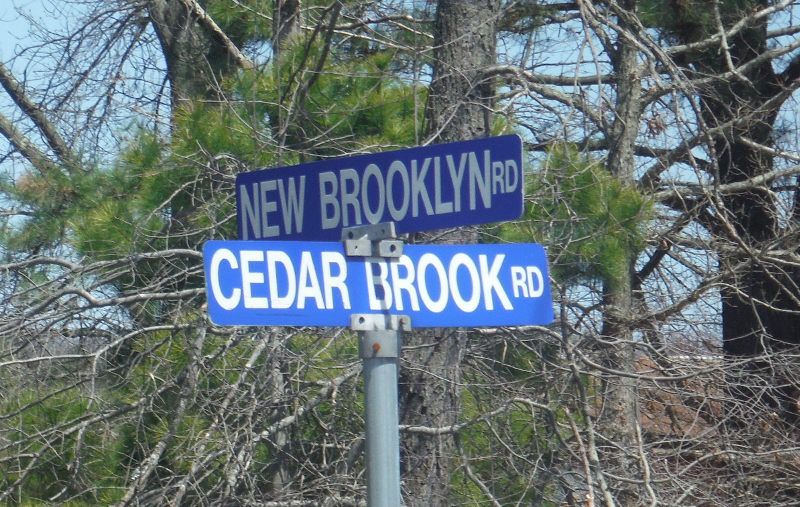 Street signs at New Brooklyn Roads and Cedar Brook Road